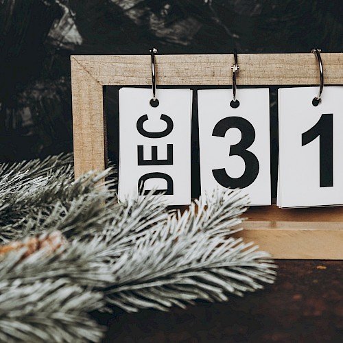 A wooden desktop calendar displaying 